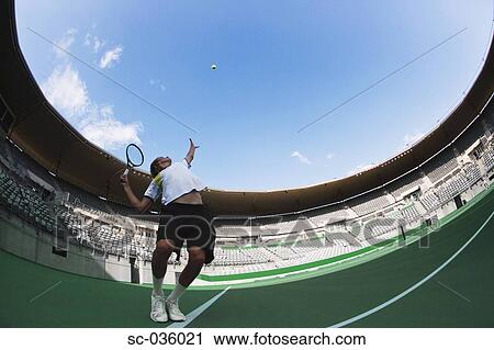Stock Image - Tennis player serving. Fotosearch
