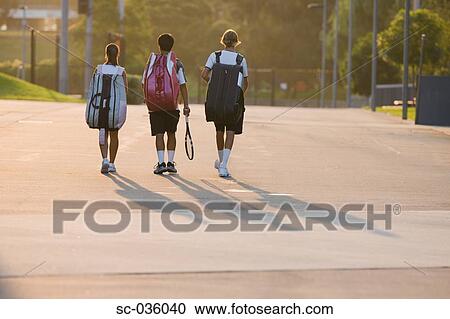 Young tennis players walking with equipment View Large Photo Image Stock Image - Young tennis players walking with equipment. Fotosearch