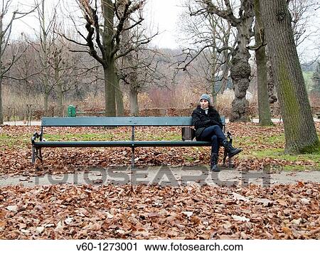 Stock Image - -Model seat in a Park in Autumn-. Fotosearch