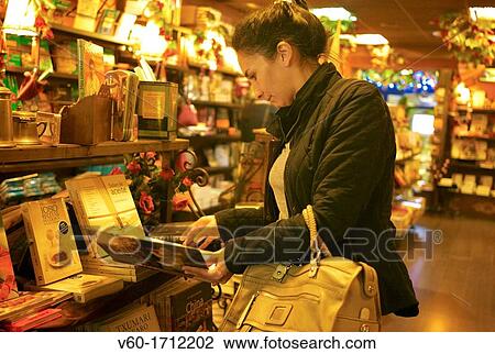 Stock Image - -Woman Looking Book-. Fotosearch