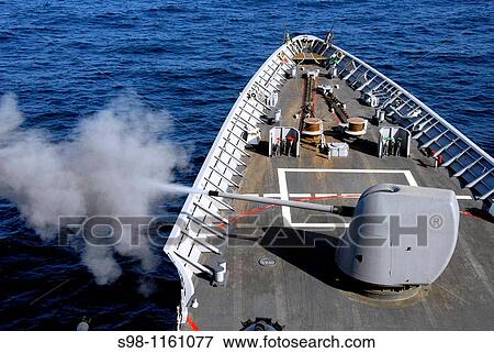 Stock Photo - 091227-N-2600H-014 GULF OF ADEN Dec 27, 2009 The 5-inch/54-caliber Mk 45 lightweight gun of the guided-missile cruiser USS Chosin CG 65 is fired during a training exercise. Fotosearch