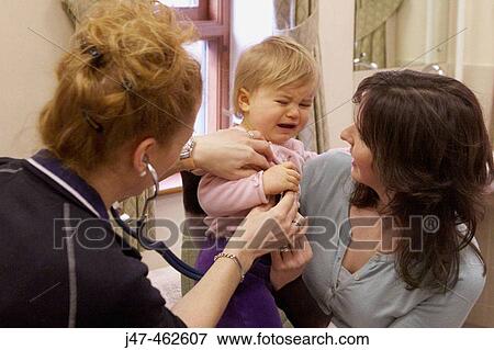 1 year old baby crying as she has her injections at the doctors View Large Photo Image Stock Photo - 1 year old baby crying as she has her injections at the doctors. Fotosearch