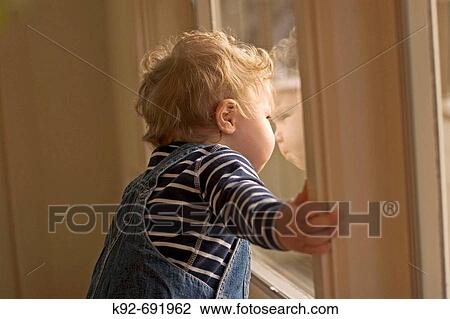 1 year old child looking out a window View Large Photo Image Stock Image - 1 year old child looking out a window. Fotosearch