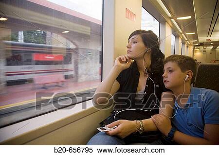 10 and 18 year old brother and sister in commuter train using iPod View Large Photo Image Stock Photography - 10 and 18 year old brother and sister in commuter train using iPod. Fotosearch
