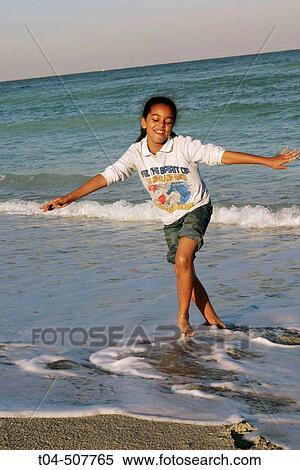 Stock Photography - 10-year-old biracial girl at beach. Miami, Florida, USA. Fotosearch