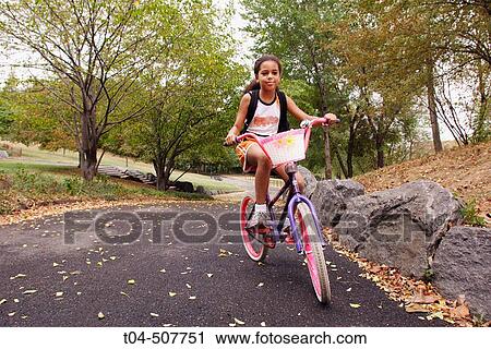 10-year-old biracial girl on a bicycle in Morningside Park, NYC. USA View Large Photo Image Stock Image - 10-year-old biracial girl on a bicycle in Morningside Park, NYC. USA. Fotosearch