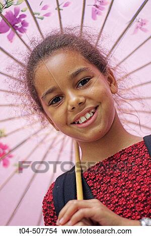 10-year-old biracial girl smiling with umbrella View Large Photo Image Picture - 10-year-old biracial girl smiling with umbrella. Fotosearch