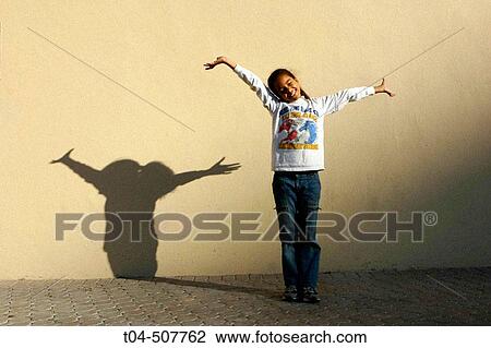 Stock Image - 10-year-old biracial girl stretching arms. Miami, Florida, USA. Fotosearch