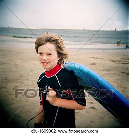 10 year old boy carrying a body-board on the beach at Westward Ho!, Devon, England Taken with a Holga medium format toy camera View Large Photo Image Stock Image - 10 year old boy carrying a body-board on the beach at Westward Ho!, Devon, England Taken with a Holga medium format toy camera. Fotosearch