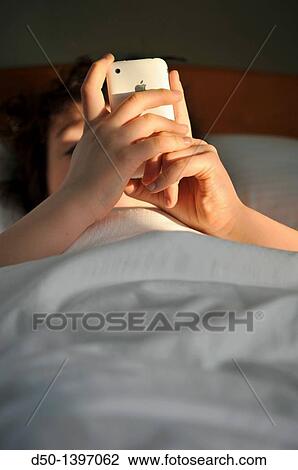 10 year old boy playing games on his iPhone while in bed, Zakopane, Poland View Large Photo Image Stock Image - 10 year old boy playing games on his iPhone while in bed, Zakopane, Poland. Fotosearch
