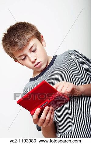 10 year old boy playing with a Nintendo DS handheld games console in the studio View Large Photo Image Stock Image - 10 year old boy playing with a Nintendo DS handheld games console in the studio. Fotosearch