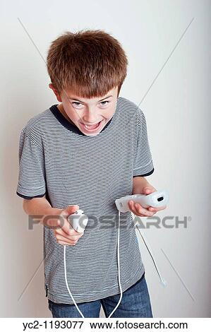 10 year old boy playing with a Nintendo Wii remote and numchuck in the studio View Large Photo Image Stock Photo - 10 year old boy playing with a Nintendo Wii remote and numchuck in the studio. Fotosearch