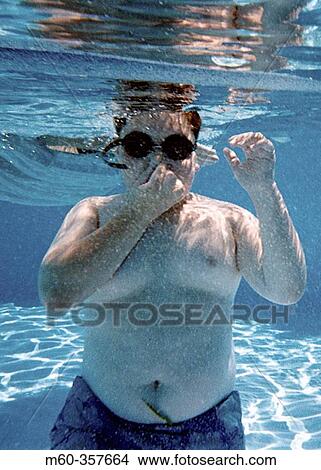 Picture - 10 year old boy under the water. Fotosearch