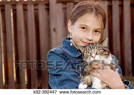 10-year-old girl and her cat standing in her backyard in Annapolis, Maryland View Large Photo Image Stock Photo - 10-year-old girl and her cat standing in her backyard in Annapolis, Maryland. Fotosearch