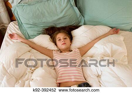 10 year old girl lying on a bed View Large Photo Image Stock Image - 10 year old girl lying on a bed. Fotosearch