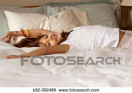10 year old girl on a bed View Large Photo Image Stock Photo - 10 year old girl on a bed. Fotosearch