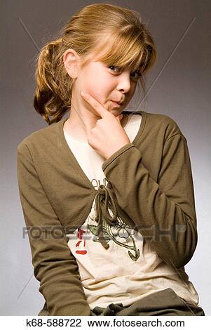 Stock Image - 10 year old girl, studio portrait, expression, making a face. Fotosearch