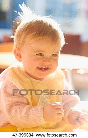 11 month old baby sitting with bib on smiling, excited View Large Photo Image Picture - 11 month old baby sitting with bib on smiling, excited. Fotosearch