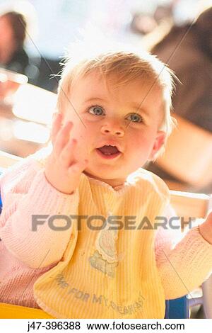 11 month old baby sitting with bib on smiling, clapping her hands View Large Photo Image Stock Photo - 11 month old baby sitting with bib on smiling, clapping her hands. Fotosearch