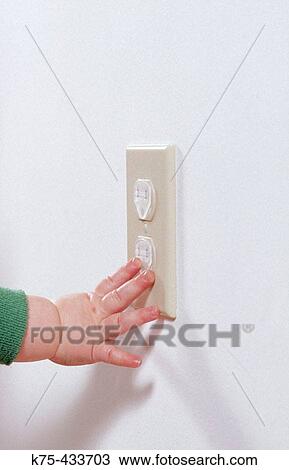 11 month old child touching safety cover on socket View Large Photo Image Stock Image - 11 month old child touching safety cover on socket. Fotosearch