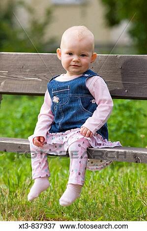 11 months old baby girl sitting on a bench View Large Photo Image Stock Photo - 11 months old baby girl sitting on a bench. Fotosearch