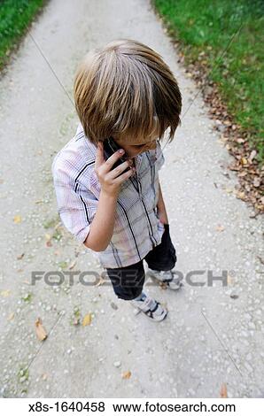 11 year old boy talking onhis mobile phone View Large Photo Image Stock Photo - 11 year old boy talking onhis mobile phone. Fotosearch