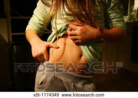 11 year old girl is checking for fats on her body She started dieting after convincing herself that she must diet in order to become a woman, and a beautiful one In Western Society the age for dieting is dropping rapidly each year View Large Photo Image Stock Photo - 11 year old girl is checking for fats on her body She started dieting after convincing herself that she must diet in order to become a woman, and a beautiful one In Western Society the age for dieting is dropping rapidly each year. Fotosearch