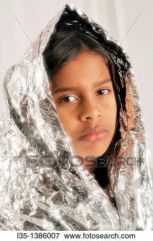 11 year old Indian girl wrapped in silver foil looks like a Maddonna View Large Photo Image Stock Photo - 11 year old Indian girl wrapped in silver foil looks like a Maddonna. Fotosearch