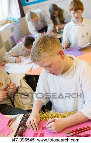 12 year old boy, sitting in a classroom drawing View Large Photo Image Stock Photography - 12 year old boy, sitting in a classroom drawing. Fotosearch