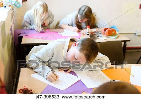 12 year old boy, sitting in class, concentrating, drawing View Large Photo Image Stock Image - 12 year old boy, sitting in class, concentrating, drawing. Fotosearch