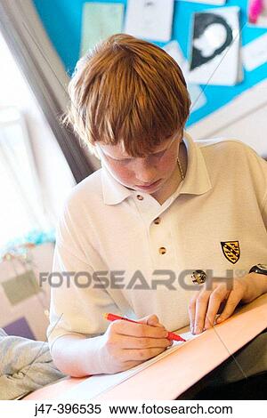 12 year old boy, sitting in class, concentrating, drawing View Large Photo Image Stock Photography - 12 year old boy, sitting in class, concentrating, drawing. Fotosearch