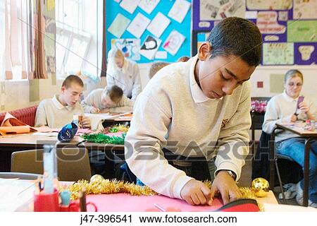 12 year old pakistani boy concentrating on drawing in a class of children View Large Photo Image Stock Image - 12 year old pakistani boy concentrating on drawing in a class of children. Fotosearch