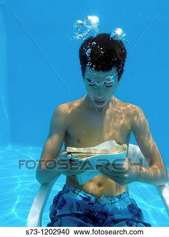 13 years old boy reading underwater View Large Photo Image Stock Image - 13 years old boy reading underwater. Fotosearch