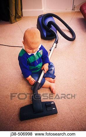 14 month old twin boy playing with hoover View Large Photo Image Stock Photo - 14 month old twin boy playing with hoover. Fotosearch