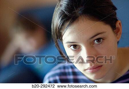 Stock Image - 14 years old teenager and 6 years old boy in background. Fotosearch
