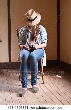 15 year old girl sits in an old abandoned house with her camera and a Panama hat over her face. View Large Photo Image Stock Image - 15 year old girl sits in an old abandoned house with her camera and a Panama hat over her face.. Fotosearch