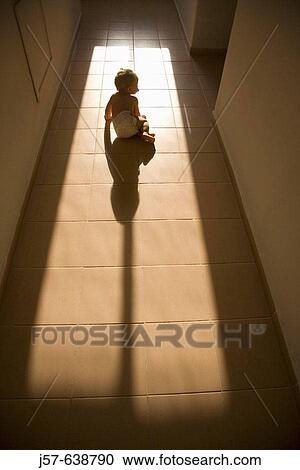 16 month old girl exploring the light coming through a hotel window in the hallway View Large Photo Image Stock Image - 16 month old girl exploring the light coming through a hotel window in the hallway. Fotosearch