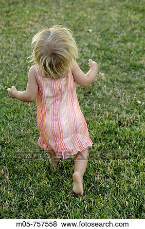 16 months old toddler running in the grass View Large Photo Image Stock Photo - 16 months old toddler running in the grass. Fotosearch