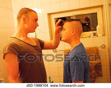 16 year old giving a haircut to his 12 year old brother. Stockholm, Sweden View Large Photo Image Picture - 16 year old giving a haircut to his 12 year old brother. Stockholm, Sweden. Fotosearch