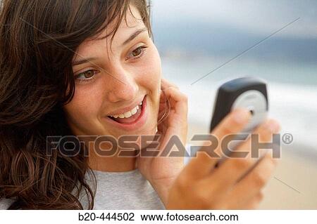 16 year old teengirl using cell phone at beach View Large Photo Image Stock Image - 16 year old teengirl using cell phone at beach. Fotosearch