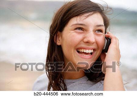 16 year old teengirl using cell phone at beach View Large Photo Image Stock Photograph - 16 year old teengirl using cell phone at beach. Fotosearch
