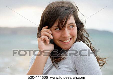 16 year old teengirl using cell phone at beach View Large Photo Image Stock Photography - 16 year old teengirl using cell phone at beach. Fotosearch