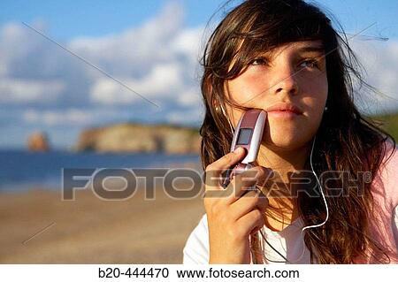 16 years old teenager listening to music in a MP3 mobile phone. Hendaye beach. Aquitaine. France. View Large Photo Image Stock Image - 16 years old teenager listening to music in a MP3 mobile phone. Hendaye beach. Aquitaine. France.. Fotosearch