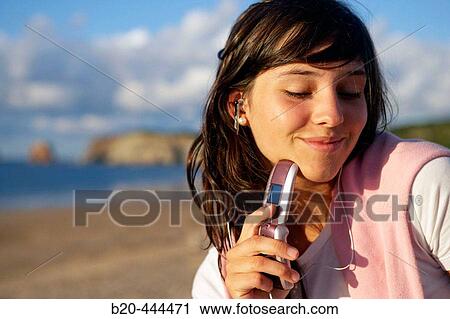 16 years old teenager listening to music in a MP3 mobile phone. Hendaye beach. Aquitaine. France. View Large Photo Image Stock Image - 16 years old teenager listening to music in a MP3 mobile phone. Hendaye beach. Aquitaine. France.. Fotosearch