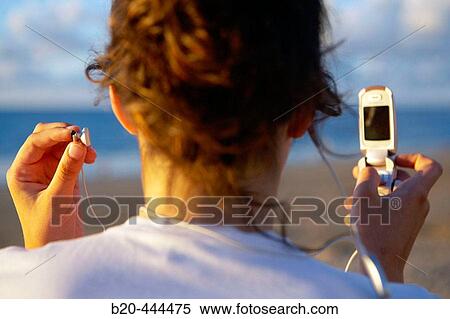 16 years old teenager listening to music in a MP3 mobile phone. Hendaye beach. Aquitaine. France. View Large Photo Image Stock Photography - 16 years old teenager listening to music in a MP3 mobile phone. Hendaye beach. Aquitaine. France.. Fotosearch