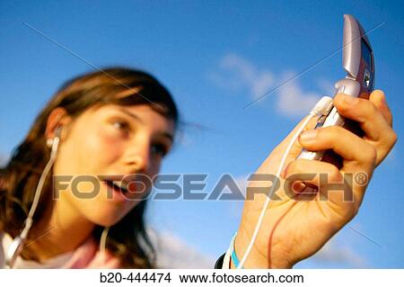 16 years old teenager taking pictures with a MP3 mobile phone. View Large Photo Image Picture - 16 years old teenager taking pictures with a MP3 mobile phone.. Fotosearch
