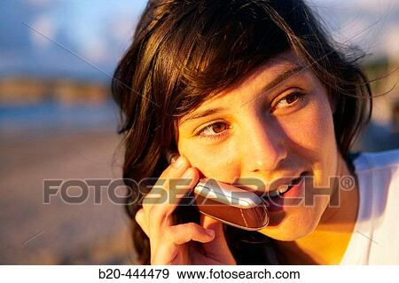 16 years old teenager talking on a mobile phone. Hendaye beach. Aquitaine. France. View Large Photo Image Stock Photo - 16 years old teenager talking on a mobile phone. Hendaye beach. Aquitaine. France.. Fotosearch