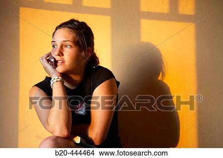 16 years old teenager with mobile phone in the evening. View Large Photo Image Picture - 16 years old teenager with mobile phone in the evening.. Fotosearch