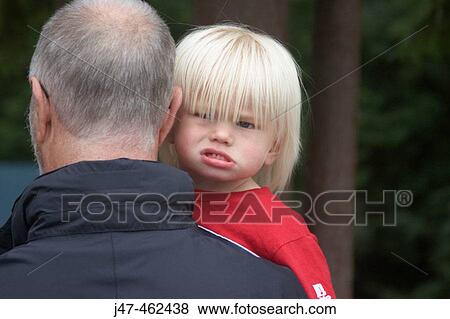 18 month old boy looking over his grandads shoulder View Large Photo Image Stock Photo - 18 month old boy looking over his grandads shoulder. Fotosearch