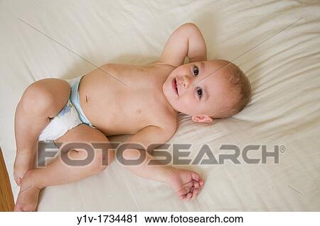 18 month old boy on a bed View Large Photo Image Stock Image - 18 month old boy on a bed. Fotosearch